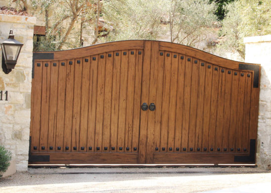 custom finished exotic hardwood single sliding gate with hand hammered cast iron accents